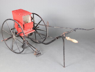 A 19th/20th Century wooden and iron seed drill with solid iron spoked wheels 170cm x 165cm x 58cm 