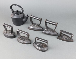 Three Victorian oval irons 9cm, 10cm, 6cm, a T. Sheldon & Co no.1 flat iron 10cm, an iron marked O 9cm, flat iron marked N3 PG 5cm and a cast iron tea kettle 16cm h