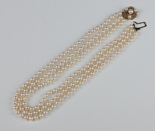 A triple strand of cultured pearls with 9ct yellow gold pearl clasp 36cm