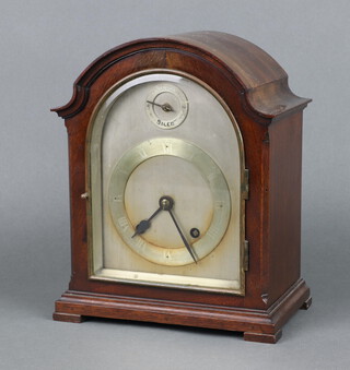 A 1930's striking bracket clock with 14cm arched silvered dial, Roman numerals, strike/silent dial, complete with pendulum and key, contained in an arched mahogany case 26cm h x 21cm w x 13cm d 