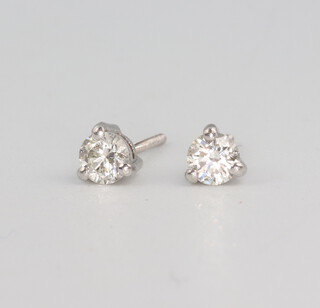 A pair of white metal single stone diamond ear studs, the butterflies stamped plat each 0.25ct, 1.8 grams