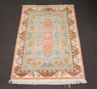 A Turkish Caucasian style orange, green and brown ground rug with 5 stylised octagons to the centre 230cm x 165cm 