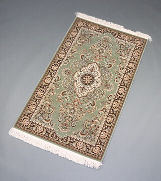 A green and grey ground Persian style machine made rug 152cm x 90cm

