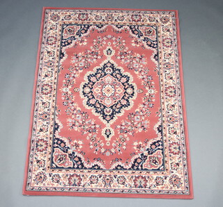 A pink and black ground Persian style rug with central medallion 172cm x 119cm 