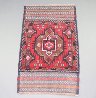 A red and blue ground Belouche rug with central medallion 140cm x 83cm 