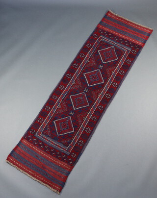 A red and blue ground Meshwani runner with 4 diamonds to the centre 243cm x 67cm 