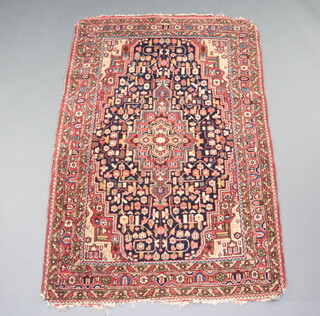 A blue and red ground North West Persian rug with central medallion 174cm x 112cm 