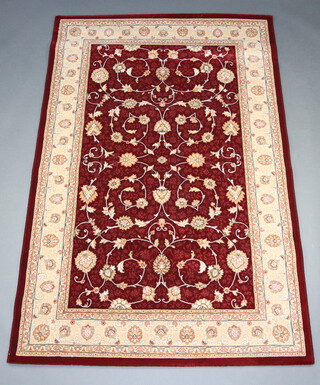 A tan and white ground machine made North West Persian style rug 208 cm x 133 