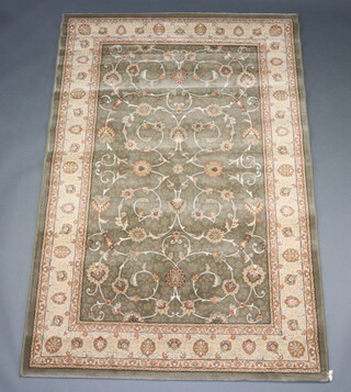 A green and gold ground machine made rug 199cm x 133cm 