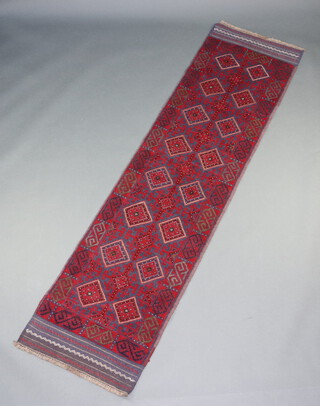 A red and blue ground Meshwani runner with 16 octagons to the centre 257cm x 60cm 