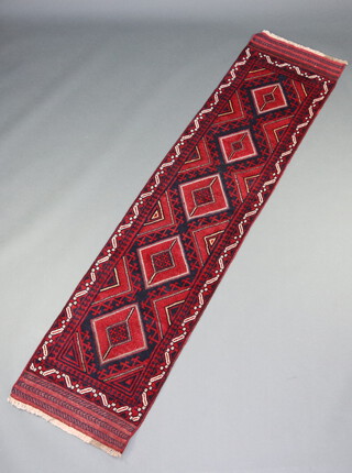 A red and blue ground Meshwani runner with 5 diamonds to the centre 266cm x 70cm 