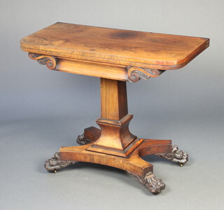 A William IV rosewood D shaped card table raised on a square column and triform base with paw feet 74cm h x 91cm w x 44cm d  