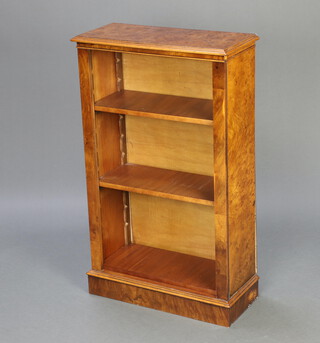 A Victorian style figured walnut bookcase fitted adjustable shelves raised on a platform base 101cm h x 61cm w x 26cm d 
