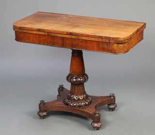 A William IV rosewood D shaped card table raised on turned and fluted column with triform base, bun feet 74cm h x 91cm w x 45cm d 