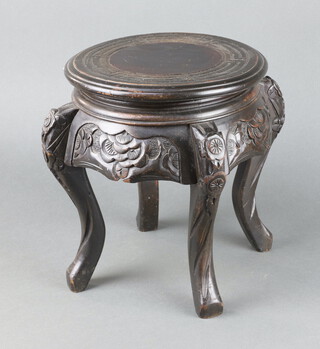 A circular Chinese carved hardwood jardiniere stand raised on cabriole supports 39cm h x 24cm diam. 