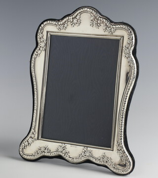 A modern repousse silver photograph frame 22cm x 16cm