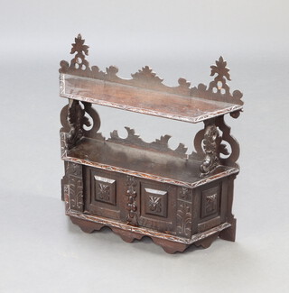 A Victorian carved oak hanging 2 tier shelf, the base enclosed by panelled doors 59cm h x 60cm w x 17cm d  