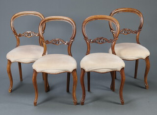 A set of 4 Victorian bleached walnut balloon back chairs with pierced and carved mid rails, overstuffed seats, raised on cabriole supports 85cm h x 43cm w x 38cm d (20cm x 24cm) 