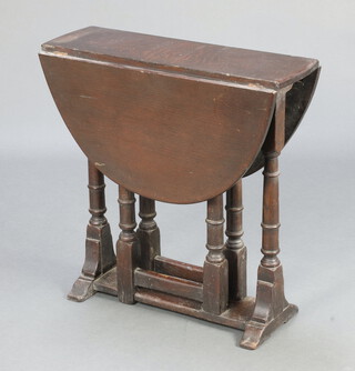 A 17th Century style oak drop flap oval gateleg tea table, raised on turned supports 67cm h x 66cm x 20cm  