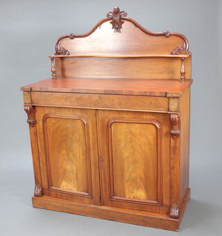 A Victorian mahogany chiffonier with raised back fitted a shelf, the base with drawer above cupboards enclosed by arched panelled doors, raised on a platform base 161cm h x 122cm w x 56cm d 