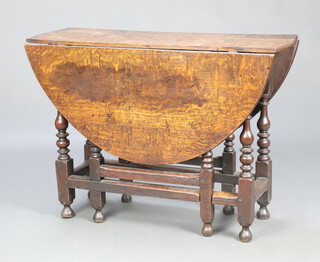 A  17th/18th Century oak oval drop flap gateleg dining table, raised on turned supports 72cm h x 100cm x 33cm 
