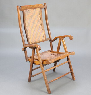An Automatic Adjusting Patent Edwardian mahogany folding campaign chair with woven rush seat and back 104cm h x 63cm w x 50cm d 

