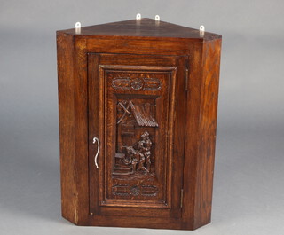 A Victorian carved oak corner cabinet, the door carved a pair of skittle bowlers 78cm h x 61cm w x 42cm d 