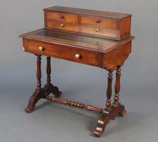 A 19th Century mahogany writing table, the raised super structure fitted 4 short drawers above writing surface, the base with 1 long drawer, on turned and reeded supports, turned stretcher 88cm h x 81cm w x 49cm d 