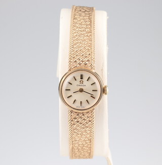 A lady's 9ct yellow gold Omega wristwatch and bracelet contained in a 16mm case, stamped 7115675, 17.3 grams including the glass, movement is stamped 485, boxed  