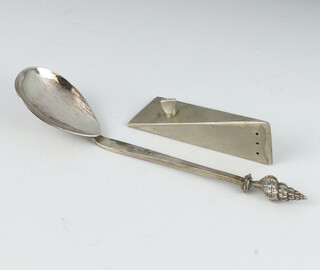 A silver caddy spoon with shell finial together with a stylish white metal angular pepper 