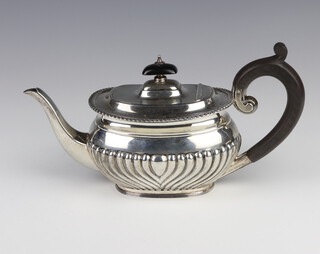 A silver fluted demi-fluted breakfast teapot with ebony mounts Sheffield 1923, gross weight 412 grams 