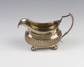 A George III silver demi-fluted cream jug on ball feet London 1816, 194 grams 
