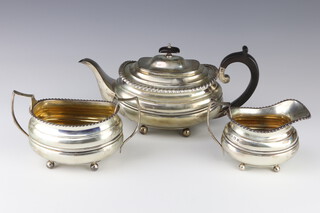 A matched 3 piece silver tea set with acanthus rims and ball feet with ebony mounts, comprising teapot, sugar bowl and cream jug, Sheffield 1925 and 1926, gross weight 1162 grams 