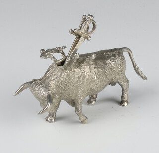 A white metal figure of a bull with 3 ditto cocktail stick swords 8.5cm 