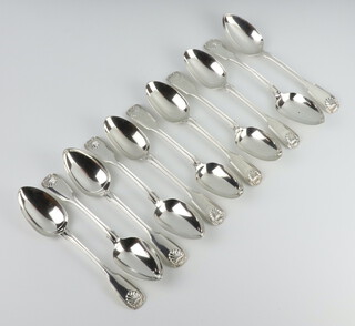 A matched set of 11 Victorian silver fiddle and shell pattern dessert spoons, London 1851,52 and 53, 5 by George Adams, the others mixed makers, 600 grams 