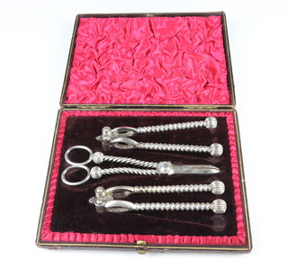 A cased set of Edwardian silver plated grape scissors and nut crackers in a fitted case 