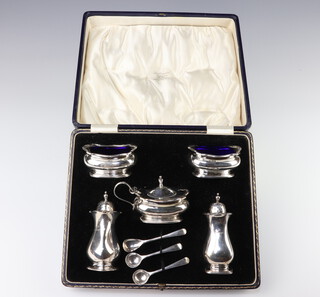 A silver 5 piece condiment with 3 spoons, Birmingham 1923, 1930, 284 grams 