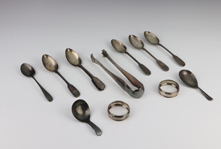 A George III silver caddy spoon, London 1799, 1 other, 7 teaspoons and 2 napkin rings, 158 grams together with a pair of plated tongs  
