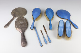 A silver and blue guilloche enamel dressing table set comprising hand mirror, 2 hair brushes (1 bruised), 2 clothes brushes, a comb mount (bruised) and a nail implement together with 2 silver backed mirrors 
