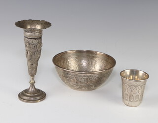 An Egyptian engraved white metal bowl decorated with geometric symbols and scrolls 11cm, a white metal tot and a repousse Indian vase 