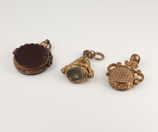 A 19th Century gilt swivel seal and 2 others