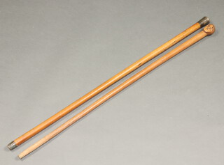 A white metal mounted cane with plain knop and a carved walking stick