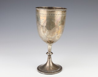 A Victorian silver trophy cup with engraved floral decoration and vacant cartouches London 1875, 26cm, 420 grams 