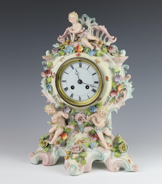 A 20th Century German porcelain rococo style clock with applied flowers and cherubs, raised on a rococo base 38cm 