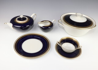 A German Weimar porcelain blue and gilt decorated tea, coffee and dinner service comprising 13 tea cups (1 a/f), 13 saucers, 12 two handled bowls, 12 saucers, 13 small plates, 12 side plates, 11 dinner plates, 2 serving plates, 2 bowls, a tureen and cover, a sauce boat, a coffee pot, a teapot, sugar bowl, 2 jugs and a salt and pepper 
