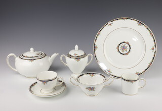 A Wedgwood Osborne pattern tea and dinner service comprising 6 two handled bowls, a teapot and lid, cream jug, milk jug and lidded sugar bowl, 7 tea cups, 6 small saucers, 7 medium saucers, 6 large saucers, cake plate, 4 small plates, 6 coffee cans, 11 dinner plates, together with a non matching Royal Worcester red banded cake plate and cake slice, both boxed 
