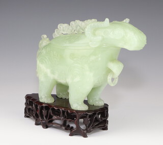 A 20th Century Chinese carved green stone box in the form of a standing mythical beast having carved pierced decoration and drop ring mount, 16cm on a hardwood stand and box 