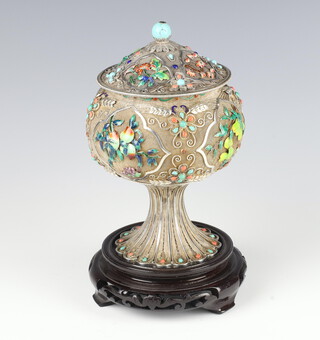 A mid 20th Century Chinese silver enamelled baluster cup with waisted stem and domed lid, decorated with flowers and bamboo, set with turquoise and coral, the body with panels of fruits, 638 grams, 18.5cm, boxed, together with a hardwood base with inscribed characters 