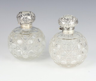A near pair of Victorian silver mounted globular glass toilet jars Birmingham 1897, 1899, 11cm 