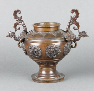A 19th Century Japanese bronze twin handled vase with roundel decoration, raised on a circular foot 19cm x 25cm 